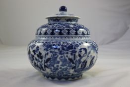 A Chinese blue and white jar and cover, late 19th century, of compressed double gourd shape, painted