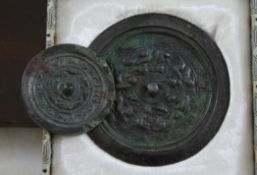 Two Chinese bronze circular mirrors, probably Tang dynasty, the larger cast in relief with chi-