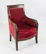 A French Empire mahogany armchair, carved with stylised foliate motifs, on sabre legs, 2ft 1in. H.