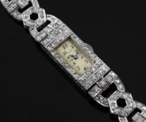 A lady`s 1930`s platinum and diamond set cocktail watch, with rectangular Arabic dial and foliate