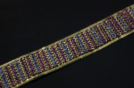 A mid 20th century 18ct gold and two colour corundum set articulated bracelet, set with rows of