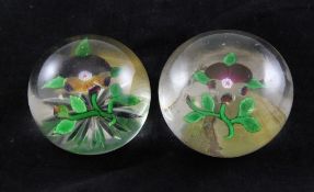 Two Baccarat Pansy glass paperweights, 19th century, one with star cut base, 2.5in. & 3in.