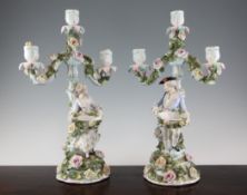 A pair of Sitzendorf figural candelabra, late 19th century, with flower encrusted branches and
