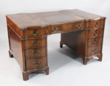A walnut partner`s desk, with serpentine top and nine drawers opposing three drawers and