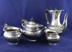 A late Victorian four piece demi fluted silver tea set, of oval form, with engraved armorial and
