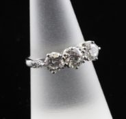 An 18ct white gold three stone diamond ring, with diamond set shoulders, total diamond weight 1.