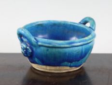 A Chinese turquoise glazed pottery twin handled small bowl, Ming dynasty, with a pair of looped