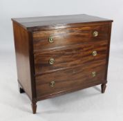 An early 19th century mahogany chest, of three long drawers, with reeded sides and circular brass