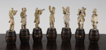 A set of seven Bavarian carved ivory musical figures, each standing on a turned wood barrel, 4.