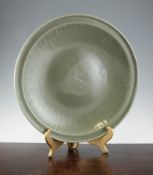 A large Chinese Longquan celadon charger, Ming dynasty, with plain dome centre and fluted border,