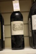 One bottle of Chateau Lafite 1983, Premier Cru Classe, Pauillac. Upper shoulder, label lightly
