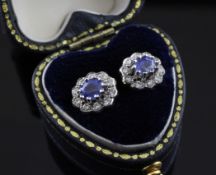 A pair of gold, sapphire and diamond cluster earrings, of flower head design.