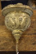 An Islamic pierced brass hanging mosque lamp, with pierced hanging chains and similar pendant,