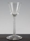 A George II incised twist stem wine glass, c.1750, with round funnel bowl and conical foot, 6.25in.