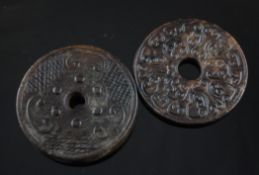 Two Chinese brown jade bi discs, the first incised with scrolls, the second with studs and