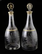 A pair of heraldic glass decanters, Silesian, circa 1770, mallet-shape with fluted and gilded necks,