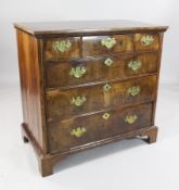 An early 18th century banded walnut chest, of three short and three long drawers, on bracket feet,