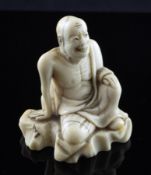 A Japanese ivory netsuke of a seated rakan, 18th / 19th century, the smiling figure seated upon a