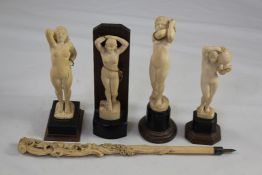 Four 1930`s Indian ivory figures of nude women, in various poses, each standing on a shaped horn and