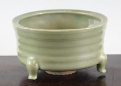 A Chinese celadon censer, Song dynasty, the ribbed body supported on three cabriole feet, unglazed