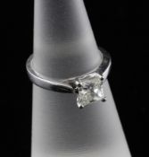 An 18ct white gold and princess cut solitaire diamond ring, the stone weighing approximately 0.55ct,