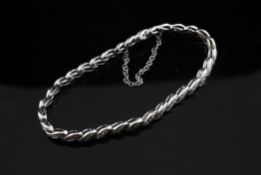 An 18ct white gold and diamond set bracelet, with stylised "s" shaped links.