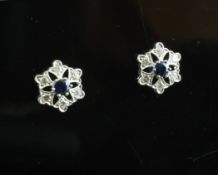 A pair of 18ct white gold, sapphire and diamond set earrings, of pierced hexagonal form.