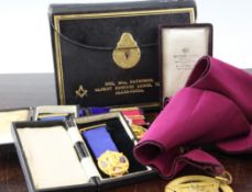 A collection of Masonic memorabilia, including two 18ct gold Masonic jewels, an apron and sash