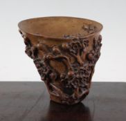 A Chinese bamboo libation cup, carved in high relief with blossoming prunus branches, 4.1in. (10.