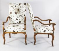 A pair of 18th century French walnut fauteuils, with upholstered backs and seats, scroll arms and