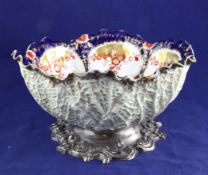 A late Victorian silver mounted ceramic fruit bowl, of circular form, with cabbage leaf exterior, on