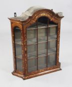 A 19th century Dutch marquetry inlaid hanging wall cupboard, with arched top and single glazed door,
