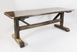 A 17th century style oak refectory table, with rounded rectangular top and trestle underframe, 6ft
