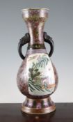 A Chinese famille rose twin handled baluster vase, late 19th century, painted with reserves of