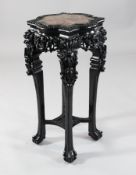 A 19th century Chinese hardwood vase stand, with marble inset shaped square top and scroll and