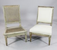 A pair of French provincial grey painted low chairs, one with caned panels, the other with pale