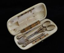 A 19th century French ivory cased five piece necessaire set, with silver gilt mounted fittings,