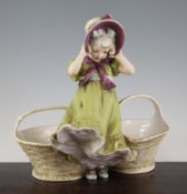 A Royal Dux figural twin section basket, modelled as a girl in a green dress wearing a ribbon tied