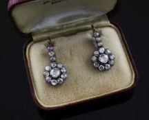 A pair of early 20th century gold and silver diamond set flower head drop earrings, 0.75in.