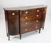 A 19th century breakfront mahogany side cabinet, with bowed end cupboard doors, the top with folding