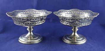 A pair of George V silver pedestal fruit comports, with pierced and engraved swag decoration and