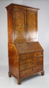 An early 18th century burr walnut bureau bookcase, with moulded cornice and two panelled doors