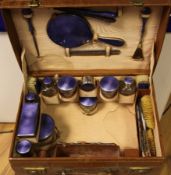 A matched George V silver and blue guilloche enamel travelling toilet set in Mappin & Webb leather