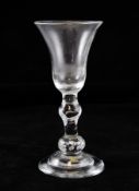 An early Georgian baluster goblet, c.1725, the bell bowl above a swelling knop set on a beaded