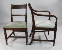 A set of five Regency mahogany dining chairs, including two carvers, with reeded frames and ring