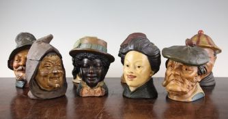 A collection of eight Austrian cold painted terracotta caricature tobacco jars and covers, early