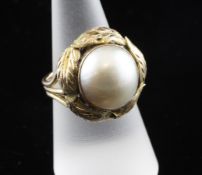 A 14ct gold and mabe pearl set dress ring, with foliate setting, size O.