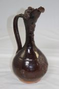 A Turkish canakkale pottery ewer, 19th century, sprigged with typical flower head motifs, brown