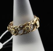 A 14ct pierced gold and diamond set band, of foliate design, size R.