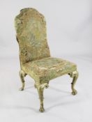A George I giltwood hall chair, with needlework upholstery depicting a couple and flowers, on